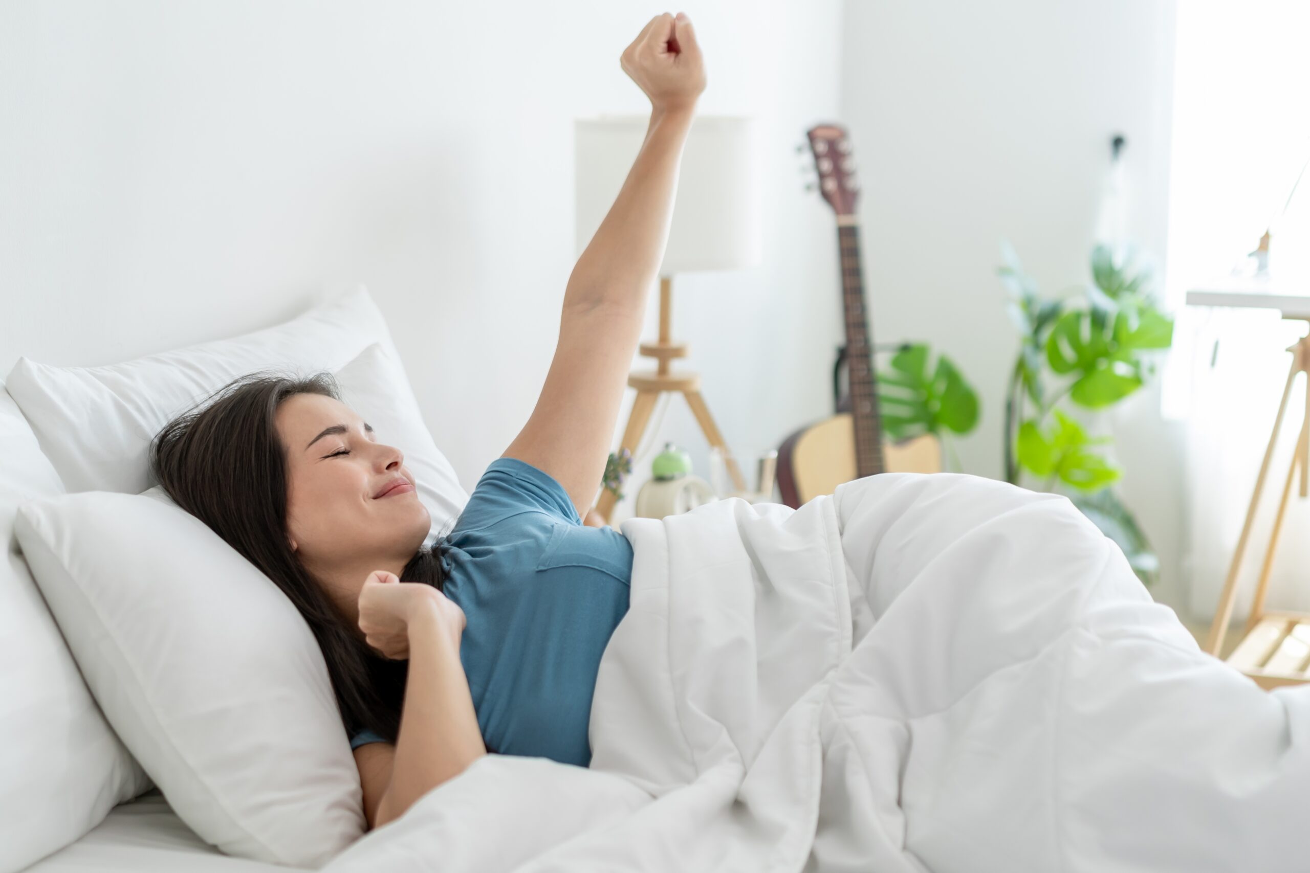 Woman waking refreshed after a good night's sleep